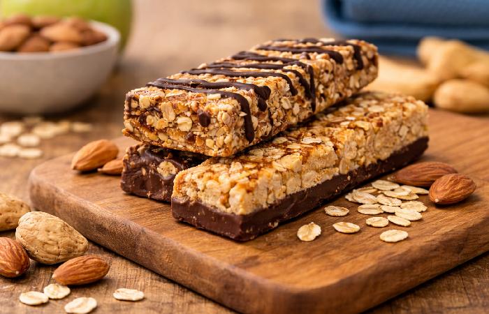 meal replacement bars with oats and nuts on wooden board