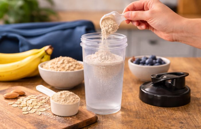 meal replacement shake being prepared with powder and ingredients
